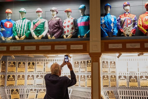 Jerry snaps a photo of the Moss silks on display at the museum. Photo courtesy of Team Zenyatta.